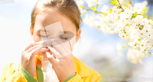 Image of Little girl is blowing her nose