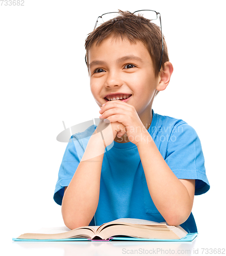 Image of Little boy is reading a book