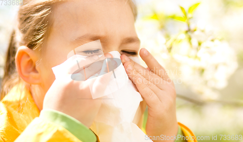 Image of Little girl is blowing her nose