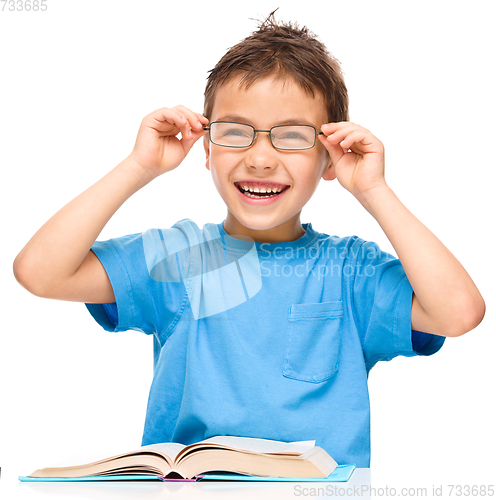 Image of Little boy is reading a book