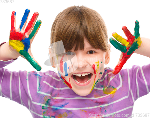 Image of Portrait of a cute girl playing with paints