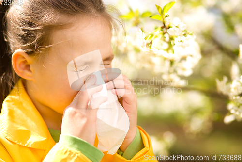 Image of Little girl is blowing her nose