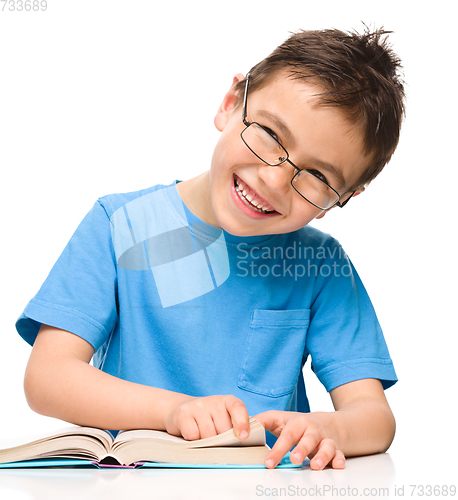 Image of Little boy is reading a book