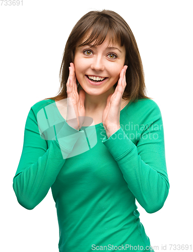 Image of Woman is holding her face in astonishment