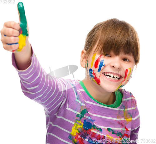 Image of Portrait of a cute girl playing with paints