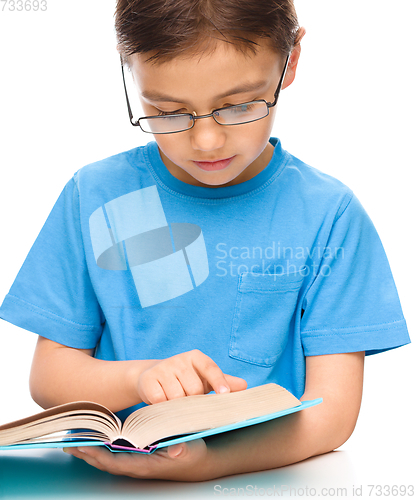 Image of Little boy is reading a book