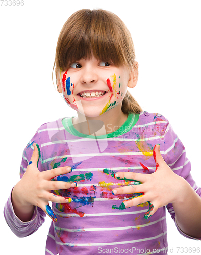 Image of Portrait of a cute girl playing with paints