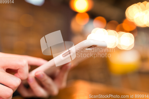 Image of Woman use on mobile phone with bokeh background