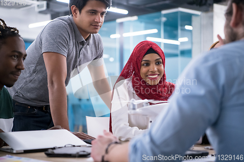 Image of multiethnic business team learning about drone technology