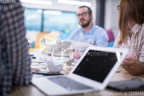 Image of multiethnic business team learning about drone technology