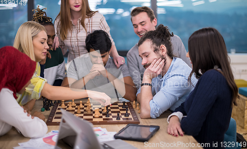 Image of multiethnic group of business people playing chess