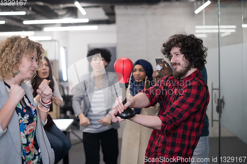 Image of multiethnics business team boxing at office