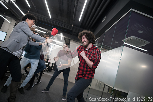 Image of multiethnics business team boxing at office