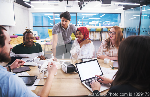 Image of multiethnic business team learning about drone technology