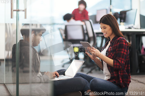 Image of software developers couple working on the floor