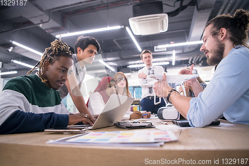 Image of multiethnic business team learning about drone technology