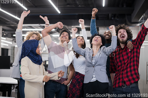Image of portrait of young excited multiethnics business team