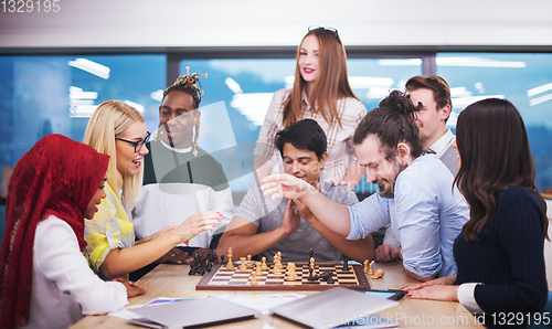 Image of multiethnic group of business people playing chess