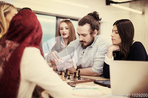 Image of multiethnic group of business people playing chess