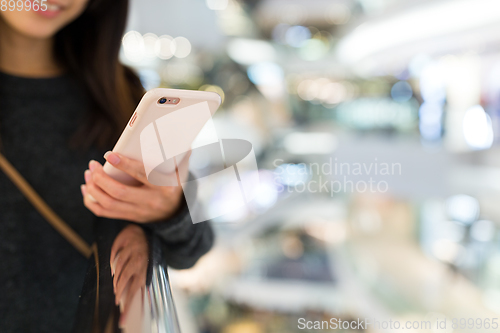 Image of Woman sending sms on mobile phone