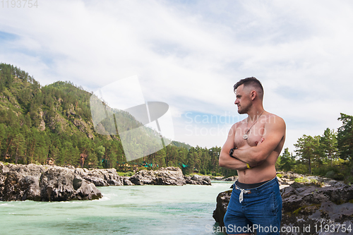 Image of Man resting at river