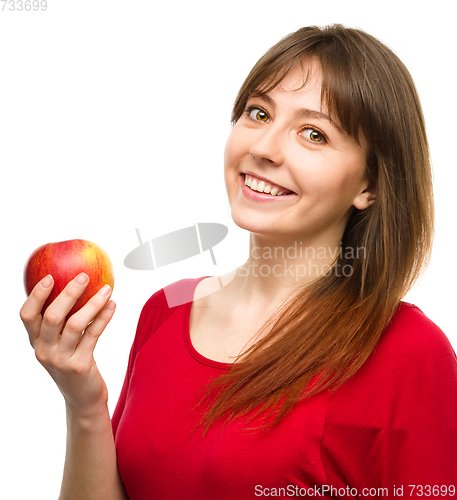 Image of Young happy girl with apple