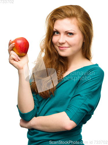 Image of Young happy girl with apple