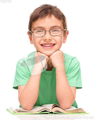 Image of Little boy is reading a book