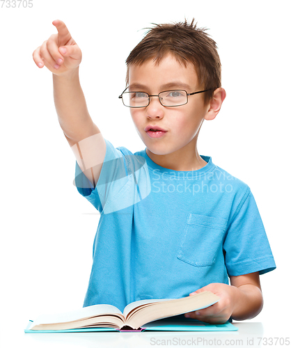 Image of Little boy is reading a book