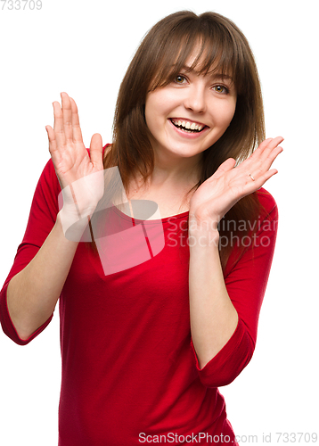 Image of Woman is holding her face in astonishment