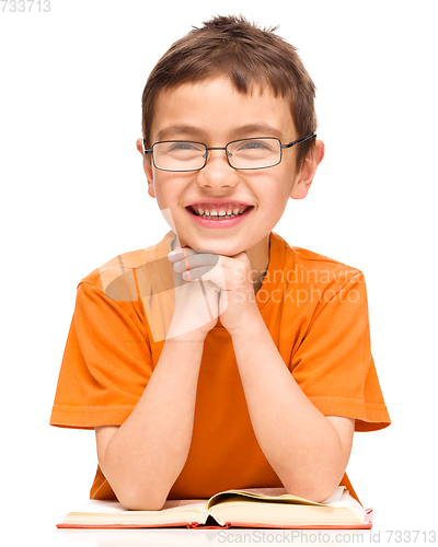 Image of Little boy is reading a book