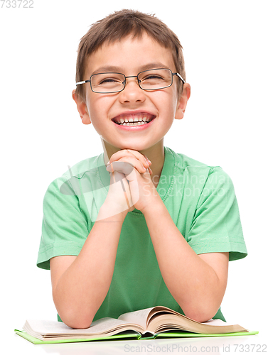 Image of Little boy is reading a book