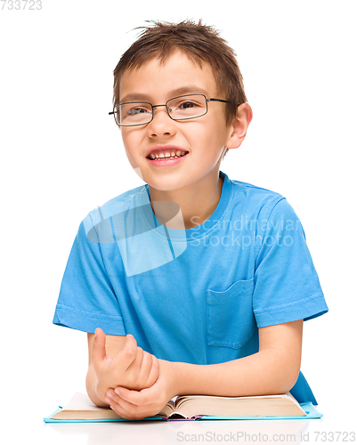 Image of Little boy is reading a book