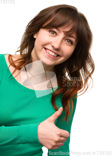 Image of Woman is showing thumb up gesture