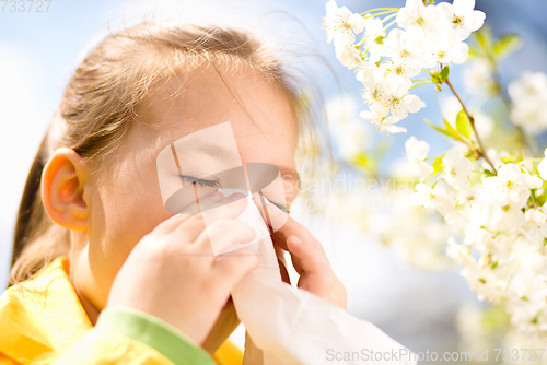 Image of Little girl is blowing her nose