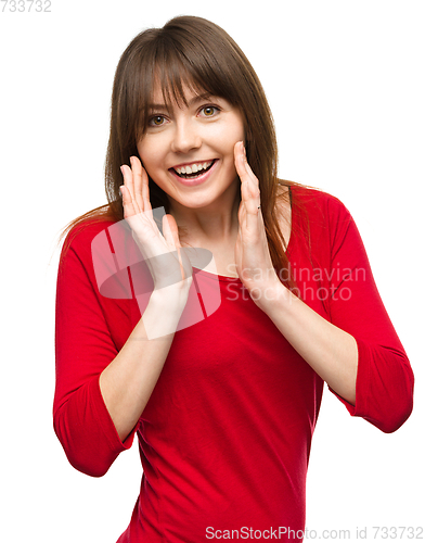 Image of Woman is holding her face in astonishment