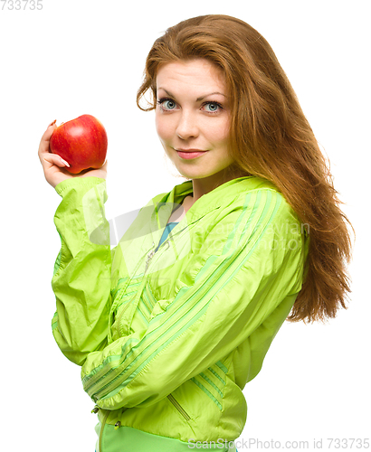 Image of Young happy girl with apple