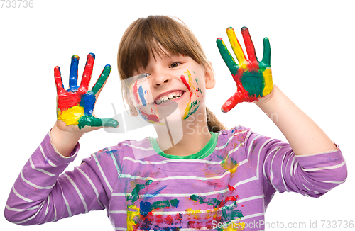 Image of Portrait of a cute girl playing with paints