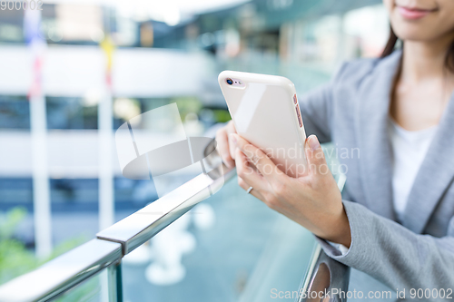 Image of Businesswoman working on cellphone