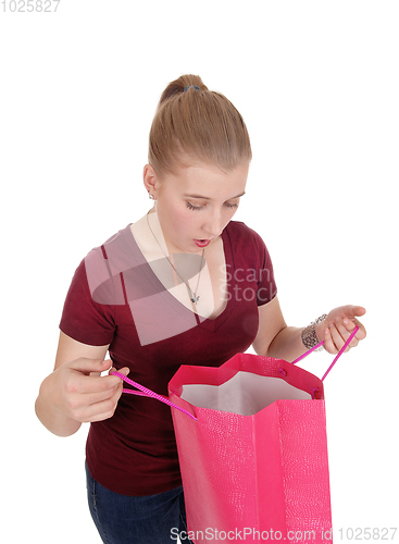 Image of Woman looking into her empty shopping bag