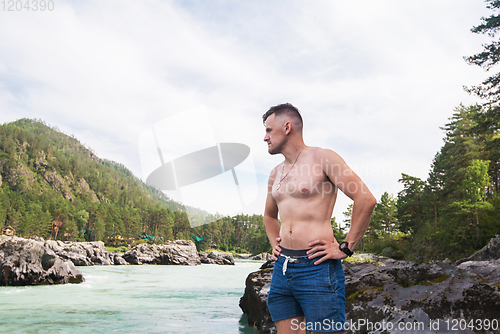 Image of Man resting at river