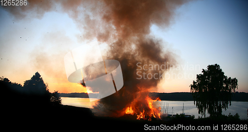 Image of Outdoor fire nearby a lake in the summer in Denmark