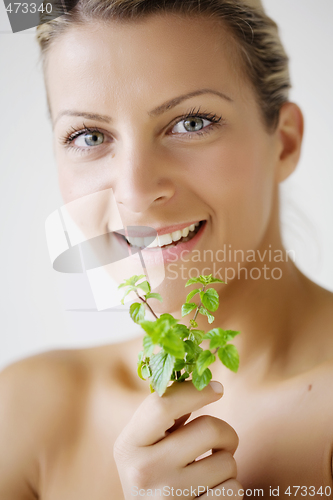 Image of woman with herb