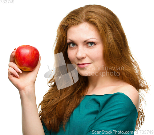 Image of Young happy girl with apple