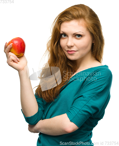 Image of Young happy girl with apple