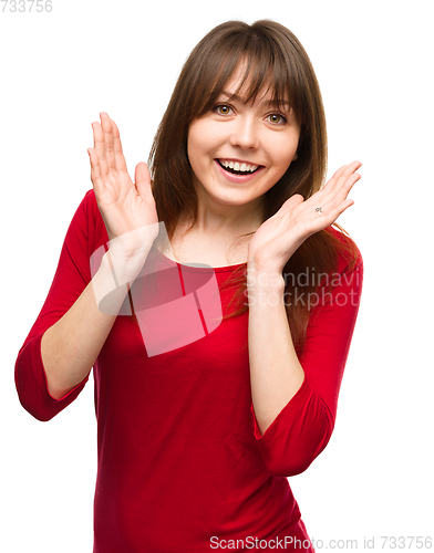 Image of Woman is holding her face in astonishment