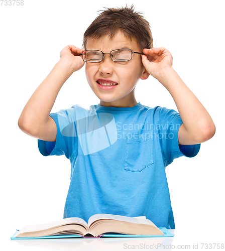 Image of Little boy is reading a book