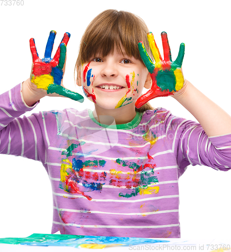 Image of Portrait of a cute girl playing with paints