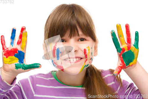 Image of Portrait of a cute girl playing with paints