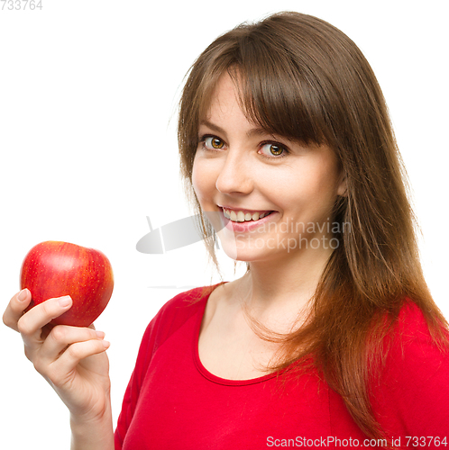 Image of Young happy girl with apple